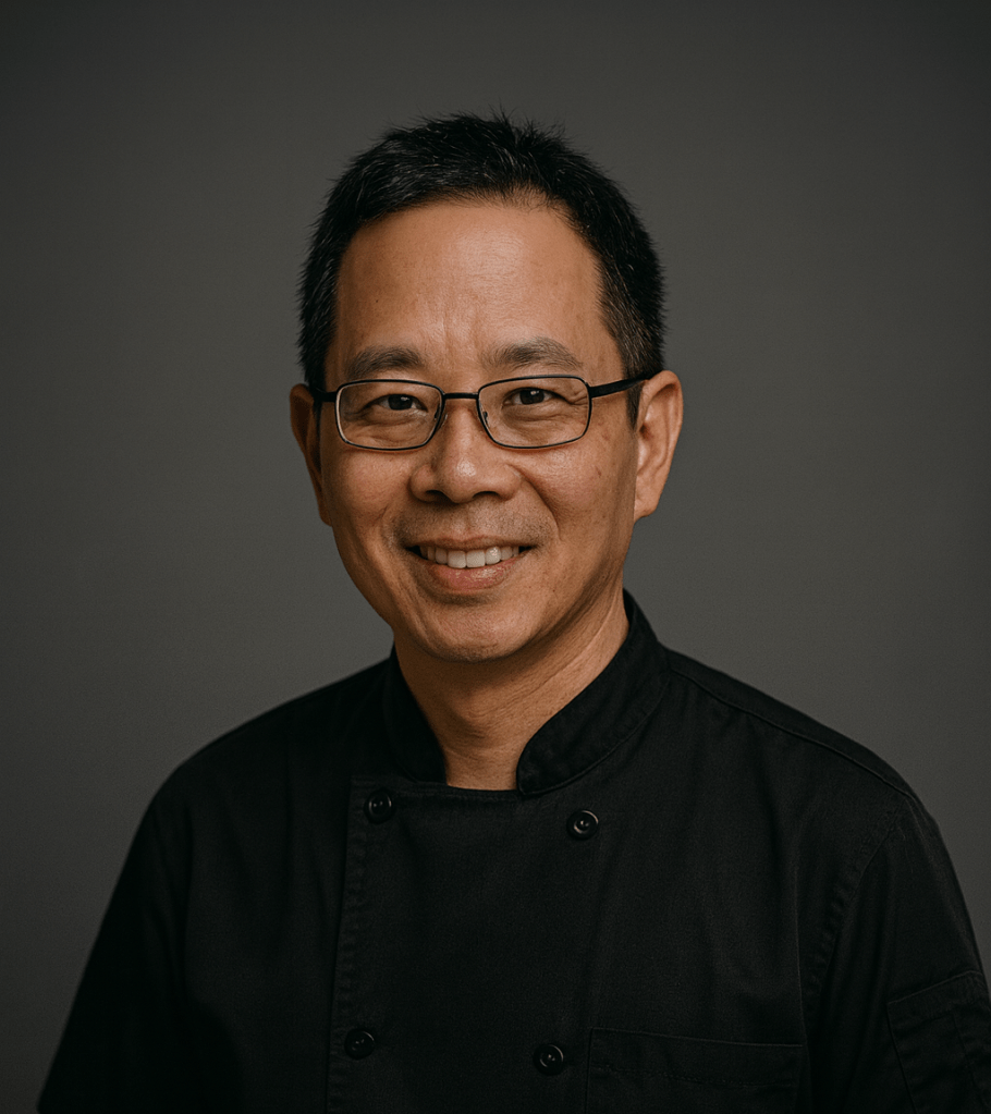 Chef John smiling in black chef uniform
