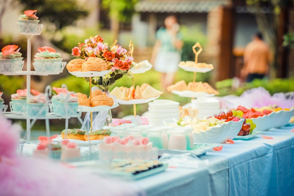 Elegant buffet table with sushi, salads, and other savory dishes at an outdoor event